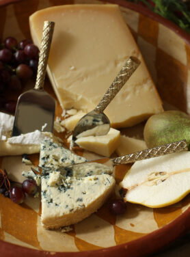 Kaasmesjes Met Gouden Kleur Op Een Plank Met Kazen Erbij