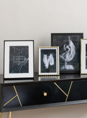 Gouden En Zwarte Fotolijstje Op Zwarte Sidetable